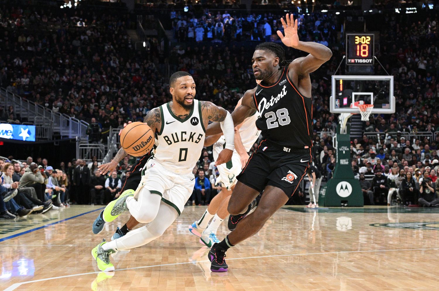 Milwaukee Bucks guard Damian Lillard dribbles to the basket against the Detroit Pistons.